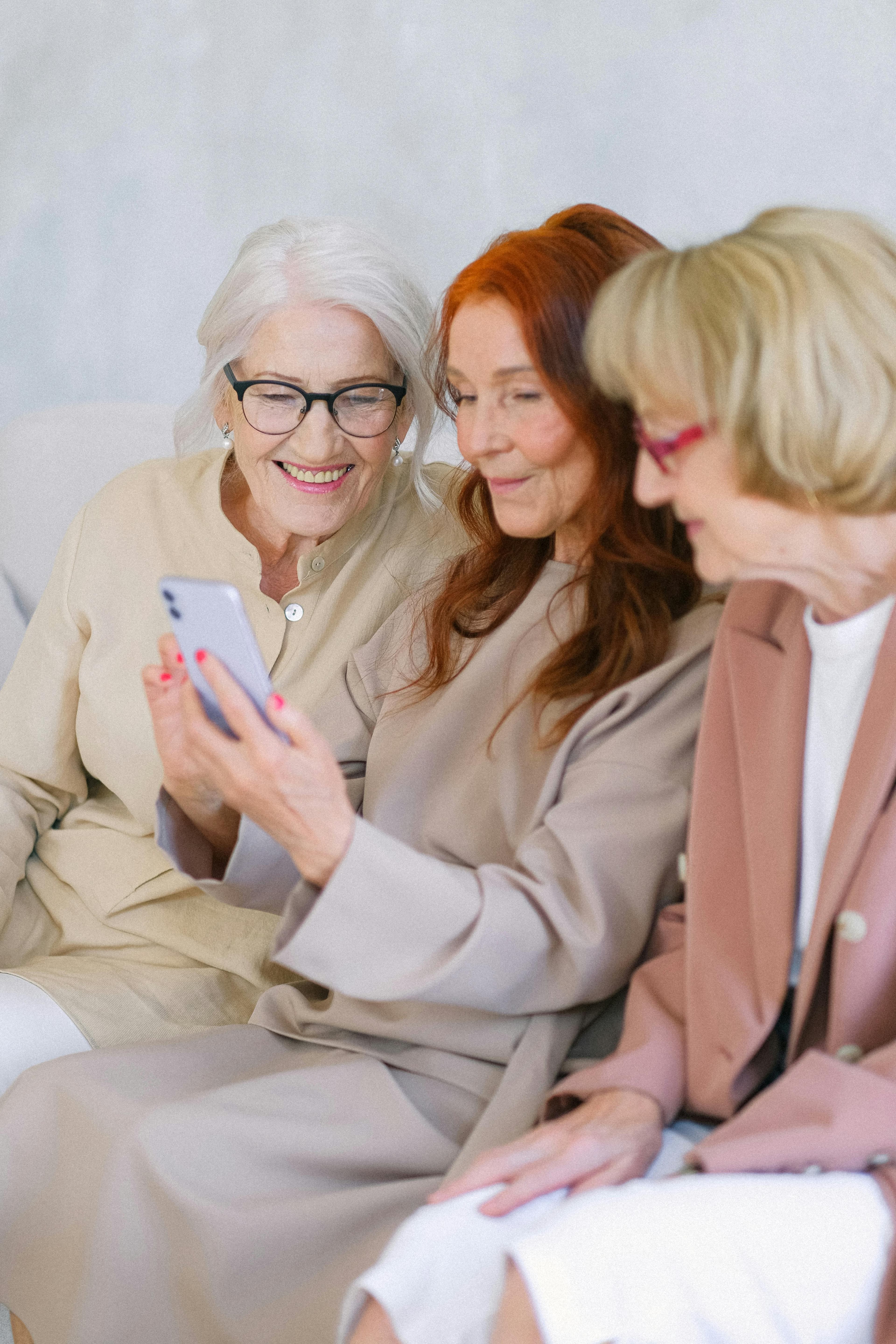 Three women looking at a phone together